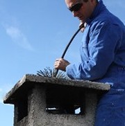 Man Cleaning a Chimney